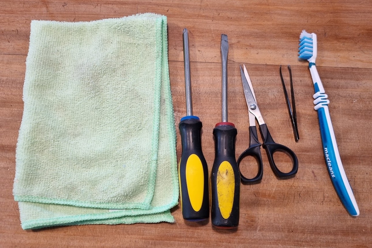 What materials are needed to clean robot vacuum sensors?